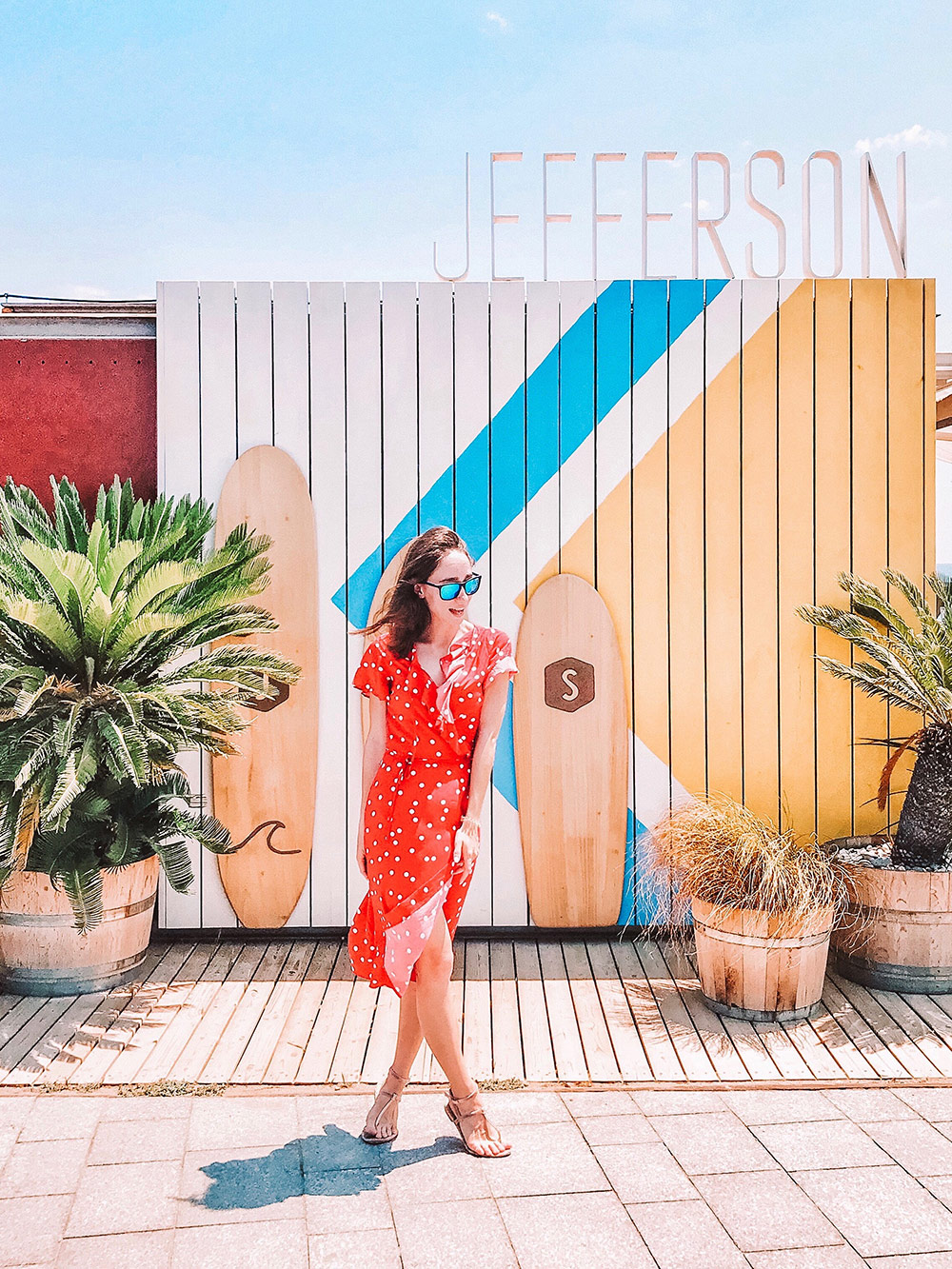 a-girl-in-a-red-dress-standing-against-a-colored-wall-summer-time-concept_t20_2WJbdP